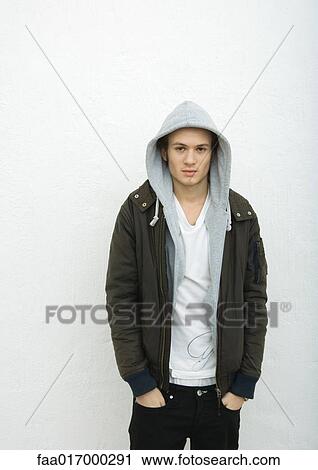 Young man with hands in pockets, portrait View Large Photo Image Stock Image - Young man with hands in pockets, portrait. Fotosearch