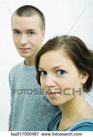 Young woman and young man, looking at camera, portrait View Large Photo Image Stock Photo - Young woman and young man, looking at camera, portrait. Fotosearch