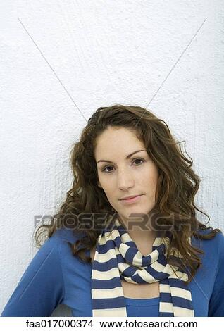Picture - Young woman looking at camera, portrait, white background. Fotosearch