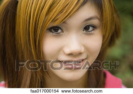Picture - Young woman, smiling at camera, close-up, portrait. Fotosearch