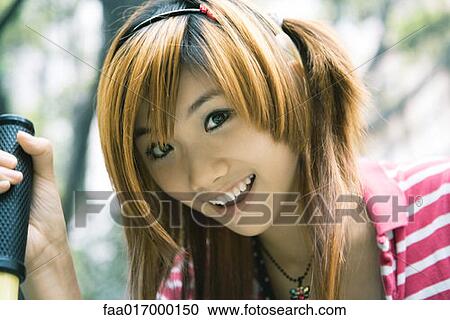 Young woman smiling, portrait View Large Photo Image Stock Image - Young woman smiling, portrait. Fotosearch