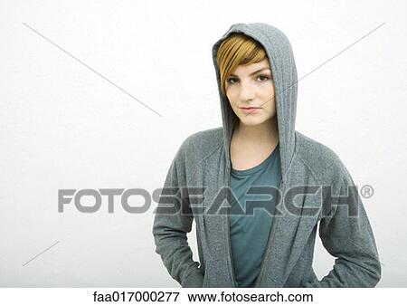 Young woman wearing hooded sweatshirt, smiling at camera View Large Photo Image Stock Photo - Young woman wearing hooded sweatshirt, smiling at camera. Fotosearch