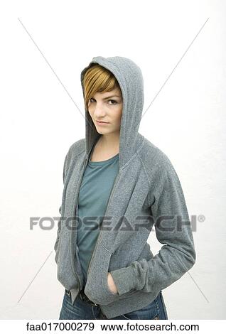 Young woman wearing hooded sweatshirt, looking at camera, portrait View Large Photo Image Stock Photo - Young woman wearing hooded sweatshirt, looking at camera, portrait. Fotosearch