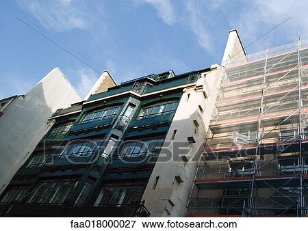 Apartment buildings, one with scaffolding, low angle view View Large Photo Image Stock Photo - Apartment buildings, one with scaffolding, low angle view. Fotosearch