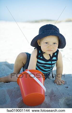 Baby playing in sand View Large Photo Image Picture - Baby playing in sand. Fotosearch