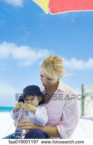 Baby with mother on beach View Large Photo Image Stock Photo - Baby with mother on beach. Fotosearch