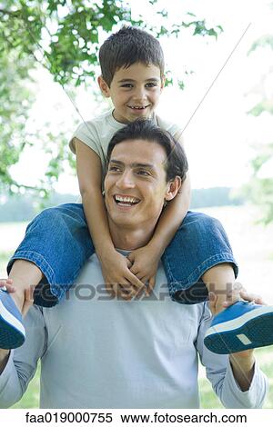 Boy and father, boy riding on man's shoulders View Large Photo Image Stock Photography - Boy and father, boy riding on man's shoulders. Fotosearch