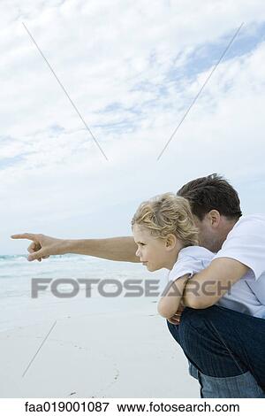 Stock Photo - Boy and father on beach. Fotosearch