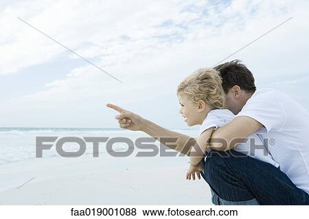 Boy and father on beach View Large Photo Image Stock Photo - Boy and father on beach. Fotosearch
