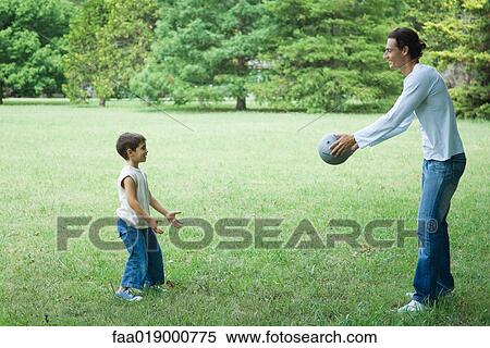 Boy and father playing ball View Large Photo Image Stock Photography - Boy and father playing ball. Fotosearch