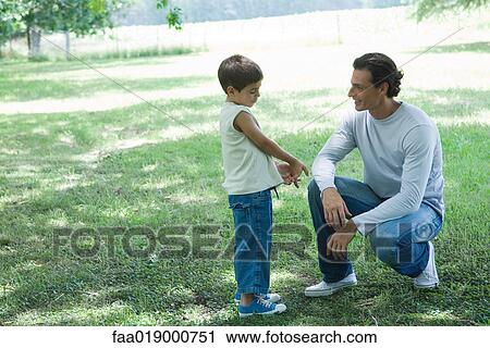 Boy and father talking outdoors View Large Photo Image Stock Image - Boy and father talking outdoors. Fotosearch