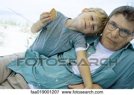 Stock Photo - Boy and grandfather on beach. Fotosearch