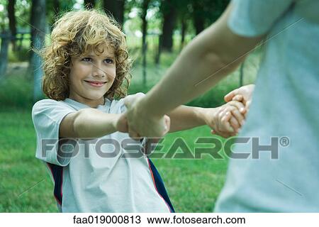 Boy holding hands with mother, partial view View Large Photo Image Stock Image - Boy holding hands with mother, partial view. Fotosearch
