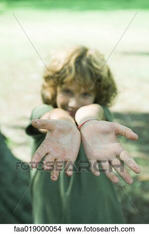 Boy holding out greasy palms View Large Photo Image Picture - Boy holding out greasy palms. Fotosearch
