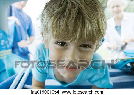 Picture - Boy in car, looking at camera. Fotosearch