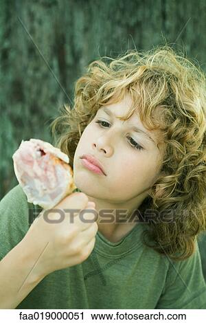 Boy inspecting grilled chicken leg View Large Photo Image Stock Image - Boy inspecting grilled chicken leg. Fotosearch