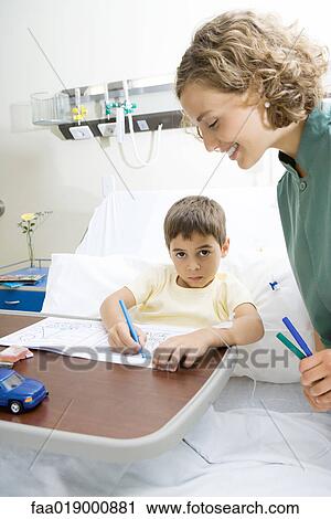 Boy lying in hospital bed, coloring View Large Photo Image Stock Image - Boy lying in hospital bed, coloring. Fotosearch