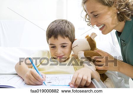 Boy lying in hospital bed, coloring View Large Photo Image Stock Image - Boy lying in hospital bed, coloring. Fotosearch
