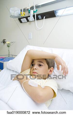 Boy lying in hospital bed View Large Photo Image Stock Image - Boy lying in hospital bed. Fotosearch