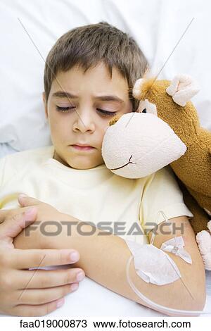 Boy lying in hospital bed View Large Photo Image Stock Image - Boy lying in hospital bed. Fotosearch