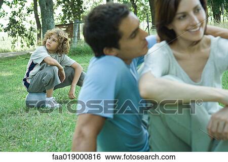 Boy sitting on ball, parents in foreground View Large Photo Image Stock Photograph - Boy sitting on ball, parents in foreground. Fotosearch