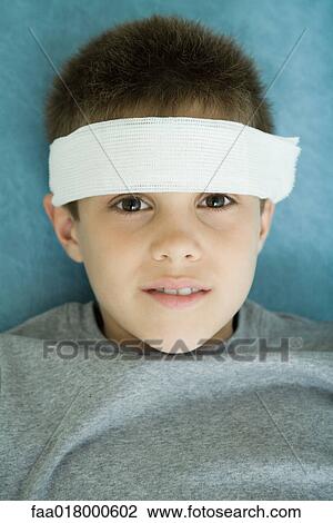 Boy with bandage on forehead, portrait, looking at camera View Large Photo Image Stock Image - Boy with bandage on forehead, portrait, looking at camera. Fotosearch