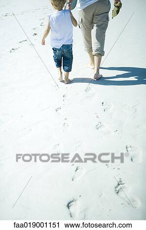 Child and adult walking on sand, low section View Large Photo Image Stock Image - Child and adult walking on sand, low section. Fotosearch