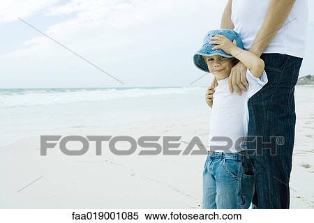 Stock Photography - Child and parent on beach. Fotosearch