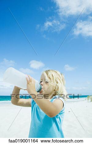 Child drinking water on beach View Large Photo Image Picture - Child drinking water on beach. Fotosearch