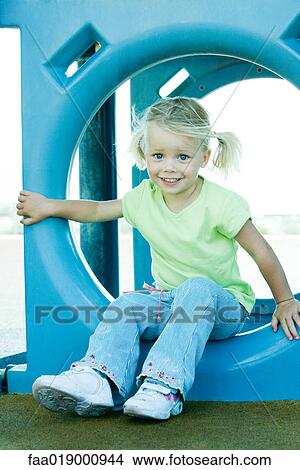 Picture - Child on playground equipment. Fotosearch