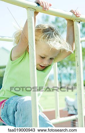 Stock Image - Child on playground equipment. Fotosearch
