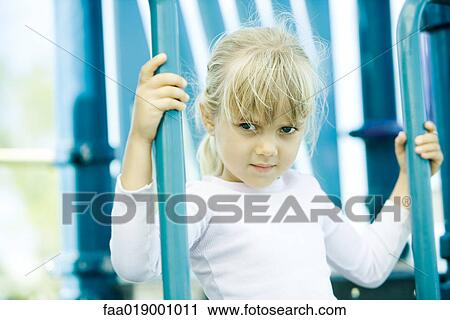 Stock Image - Child on playground equipment. Fotosearch