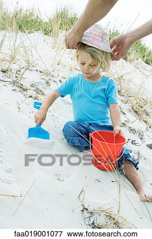 Child playing in sand View Large Photo Image Stock Photo - Child playing in sand. Fotosearch