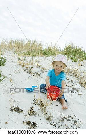 Stock Photo - Child playing in sand. Fotosearch