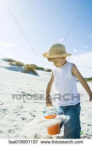 Child playing in sand View Large Photo Image Stock Photo - Child playing in sand. Fotosearch