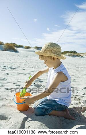 Child playing in sand View Large Photo Image Stock Photo - Child playing in sand. Fotosearch