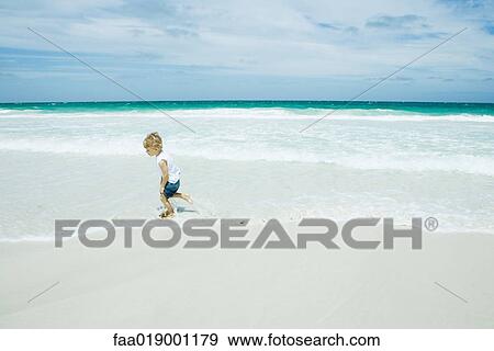 Child running in surf at beach View Large Photo Image Stock Photo - Child running in surf at beach. Fotosearch