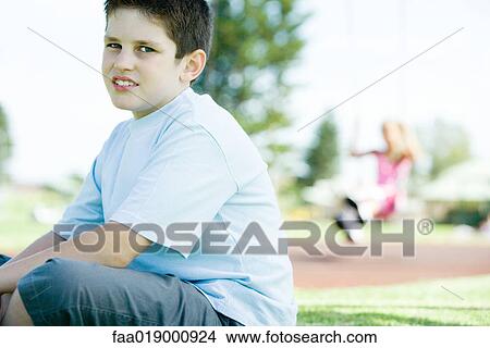 Child sitting on playground View Large Photo Image Picture - Child sitting on playground. Fotosearch