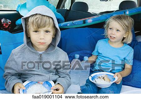 Children eating meal in back of car View Large Photo Image Picture - Children eating meal in back of car. Fotosearch