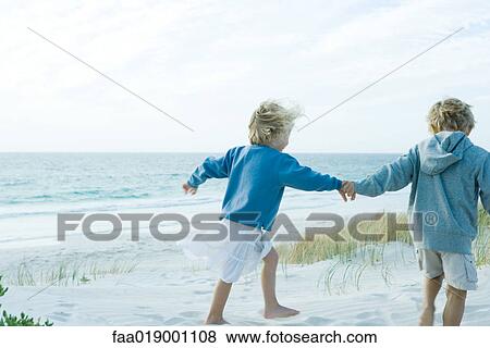 Children holding hands on beach View Large Photo Image Stock Photo - Children holding hands on beach. Fotosearch