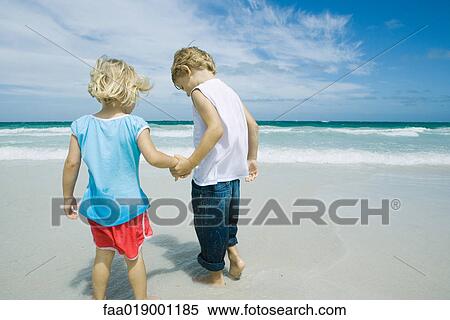 Children holding hands on beach View Large Photo Image Stock Photography - Children holding hands on beach. Fotosearch