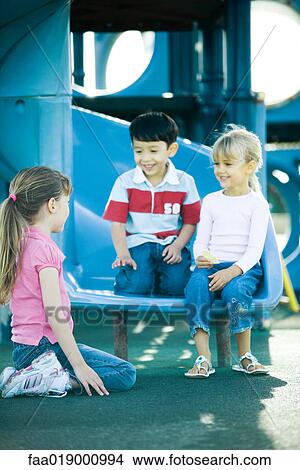 Picture - Children on playground equipment. Fotosearch