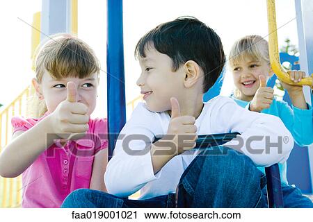 Children on playground equipment, giving thumbs up sign View Large Photo Image Stock Image - Children on playground equipment, giving thumbs up sign. Fotosearch