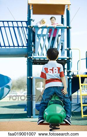 Stock Photo - Children on playground equipment. Fotosearch