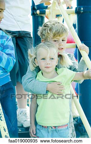 Stock Photography - Children on playground equipment. Fotosearch