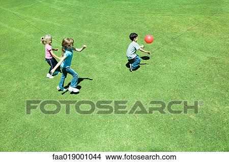 Children playing ball on grass View Large Photo Image Picture - Children playing ball on grass. Fotosearch