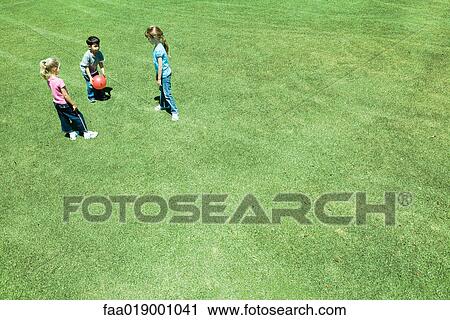 Stock Image - Children playing ball on grass. Fotosearch
