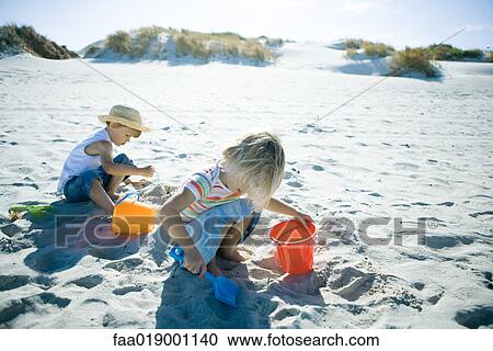 Children playing in sand View Large Photo Image Stock Image - Children playing in sand. Fotosearch