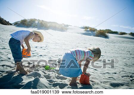 Children playing in sand View Large Photo Image Stock Photo - Children playing in sand. Fotosearch