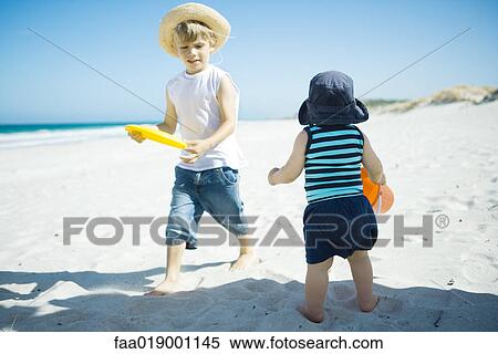 Children playing in sand View Large Photo Image Stock Photography - Children playing in sand. Fotosearch